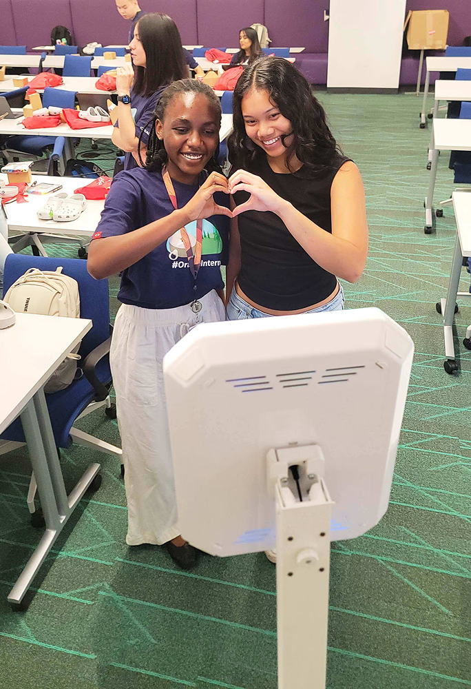 Guests making heart hands at event