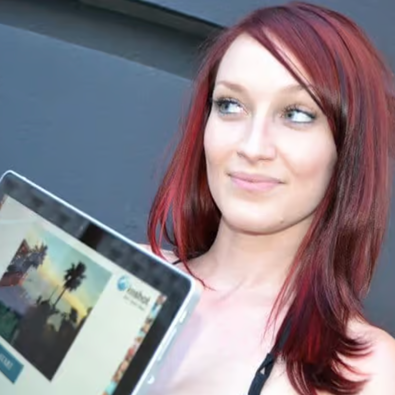 Guest posing with a tablet photo booth