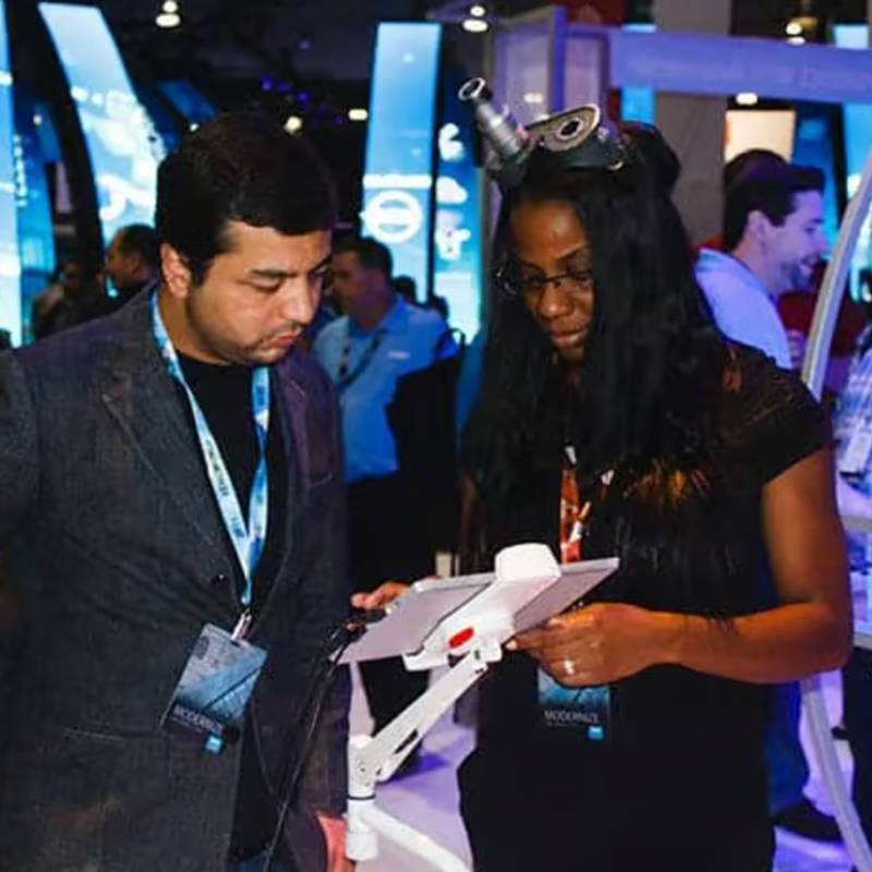 Staff member helping a guest with the tablet booth
